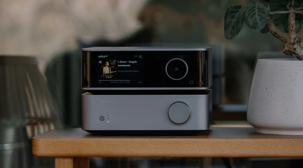 WiiM Ultra streamer and amplifier stacked on wooden side table