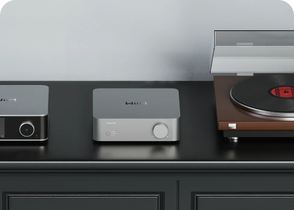 WiiM power amplifier and streamer on dark cabinet with turntable