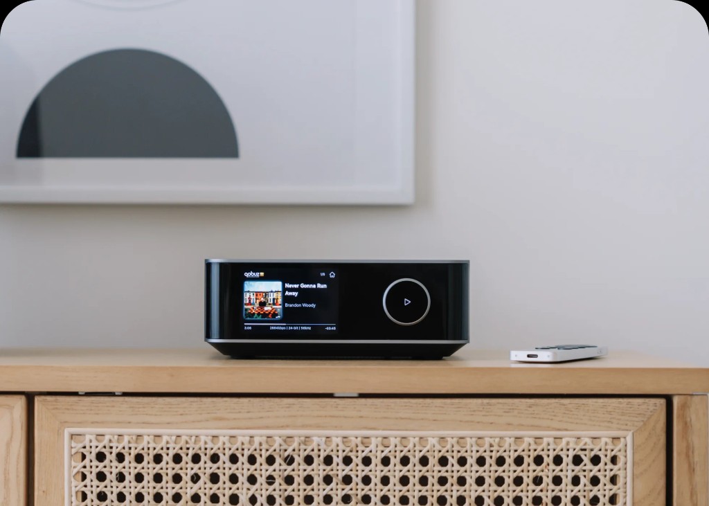 WiiM Ultra streaming amplifier on wooden sideboard